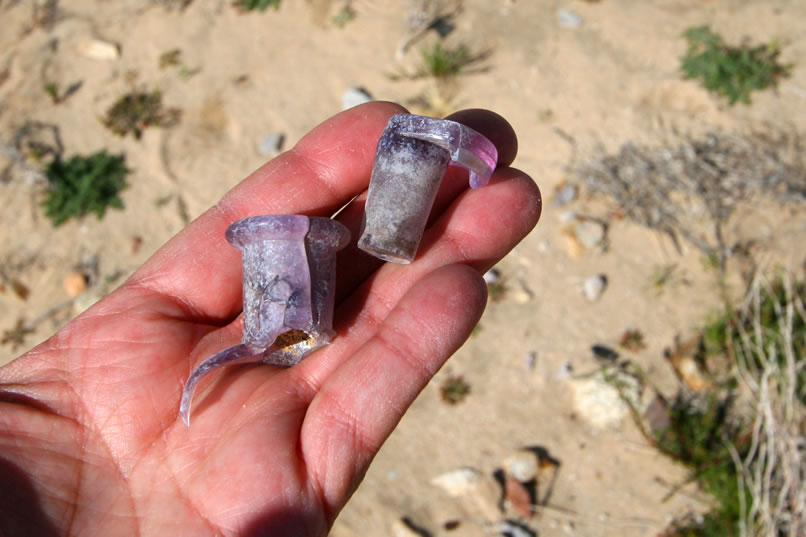 The same color change mechanism has resulted in a deeper amethyst color in this bottle fragment and glass stopper.