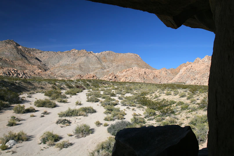 Niki makes a detour back toward a rock pile that sits near the wash and climbs up to a lofty rock shelter.  There's nothing there but the views are nice as you can see in this view from the shelter.