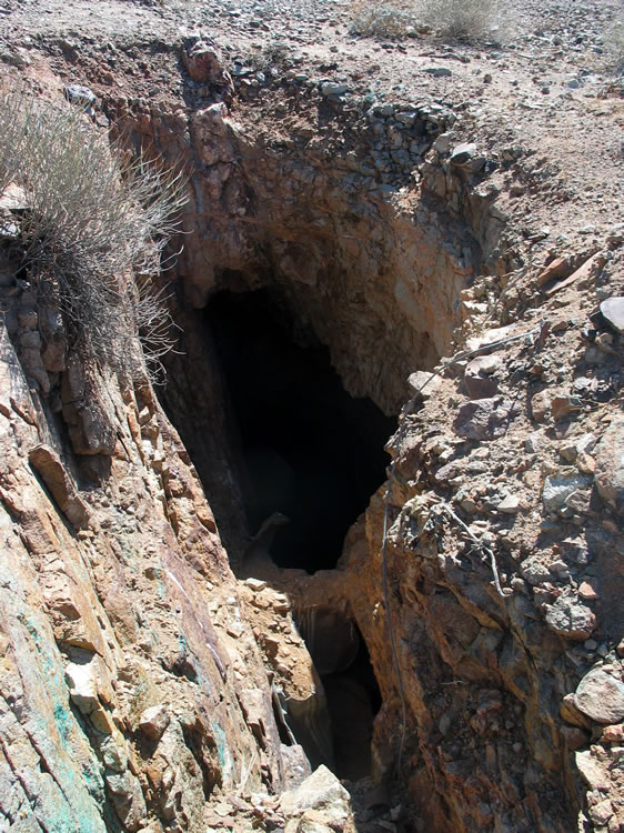 The tunnel and stopes visible below look too difficult and too dangerous to enter.  Notice the copper mineral stains in the lower left of the photo.