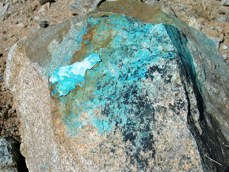 This boulder bears the stains of copper minerals.  Pieces of azurite and chrysocolla can be found in the surrounding area.