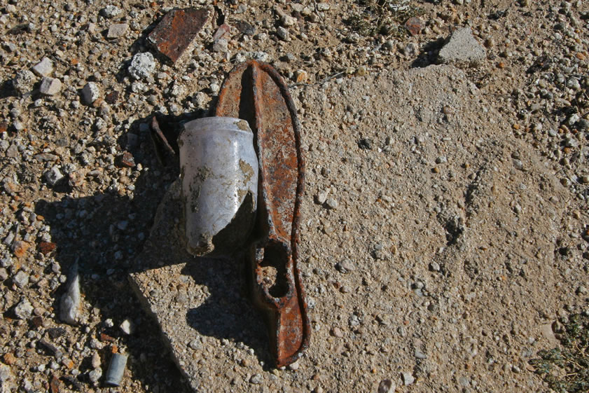 An old jar and the heavy iron last used to make or repair shoes.  Such iron lasts were parts of cobbler kits that were sold through the Sears, Roebuck & Co. catalogue as well as others.  Such kits sold for well under two dollars in the 1897 Sears catalogue.