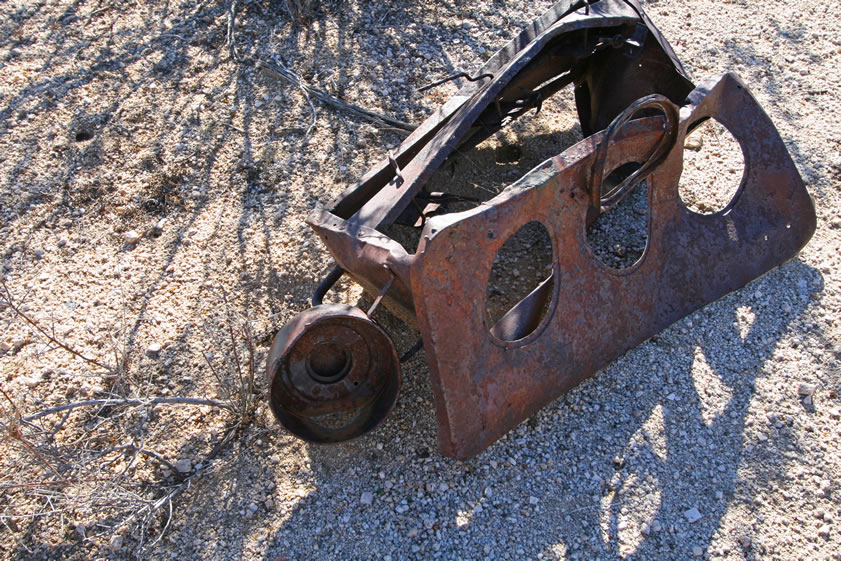 We find a couple of these old stoves.  They're pretty distinctive and a bit of detective work in old catalogues, such as the 1897 Sears Roebuck & Co. catalogue, shows that this is a gasoline stove.  The appendage to the left of the stove is where the gas container sat.