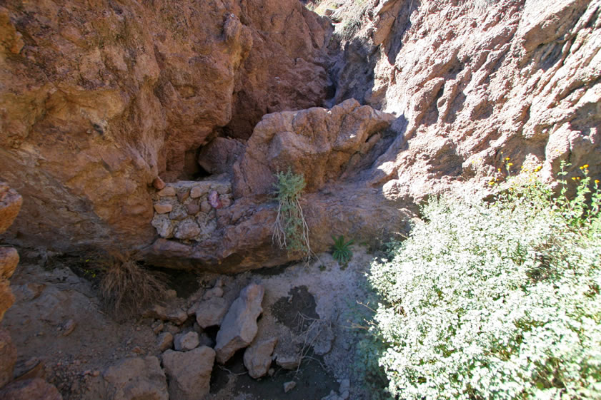 Just a few yards away we find some stone work that has enlarged a natural tank and guaranteed a seasonal supply of water.