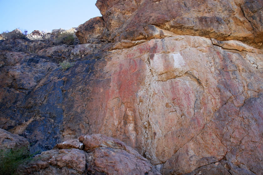 If you look closely you can just make out some of the intricate red pictographs on the rock face.  If you roll your mouse over the photo you can get an enhanced view of the rock art.