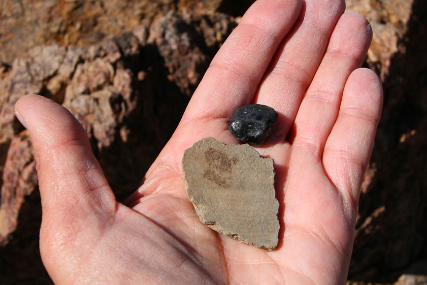 This is a view of the flip side of the pottery sherd as well as one of the rounded obsidian nodules that were also found here.