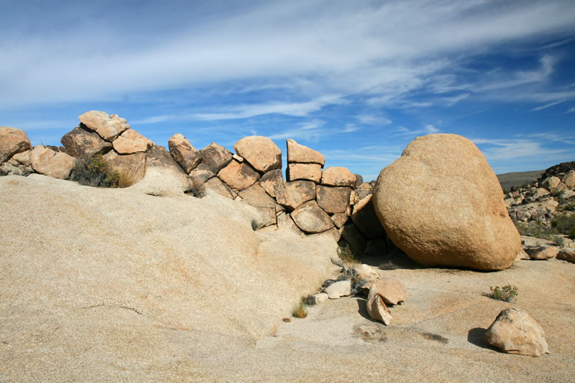 Looking for all the world like a man-made wall, this is a good example of one of the numerous erosional end products known as dikes. 