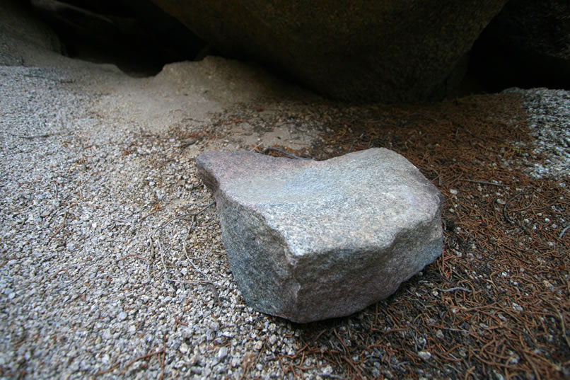 Further into the shelter is a small, worn grinding rock which would have been used in conjunction with a handstone to process seeds.