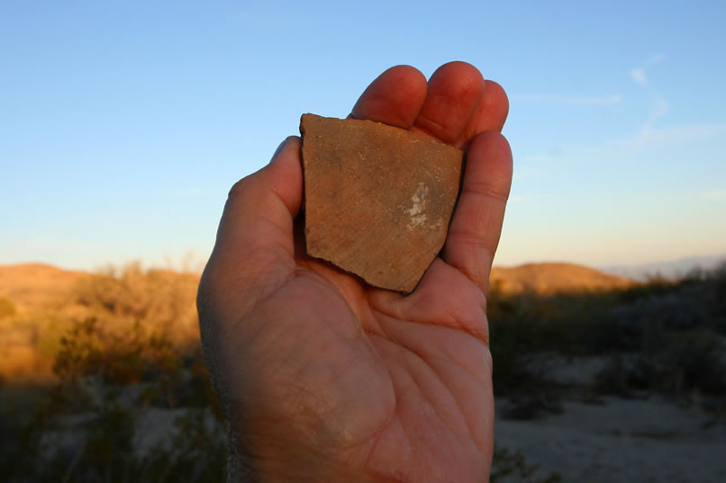 A little further down the wash we come upon some more pottery!  This is a nice large piece with a reddish finish.  After a quick photo we put it down again and trudge on.