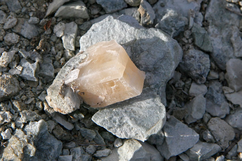 In the adjacent tailings is a large calcite crystal.