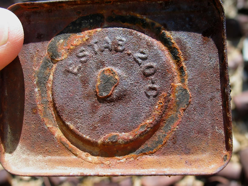 A close up of the top of a hole and cap tin.
