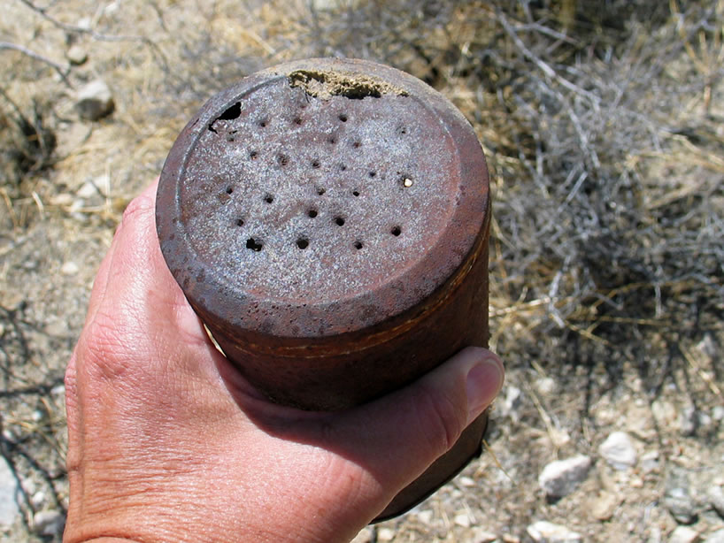 Nearby we find a can with a perforated lid.  Many times blacksmiths would make what was called a forge sprinkler by punching holes in a can lid and using it to sprinkle water around the perimeter of their forge to keep the fire focused.  Don't know if that's what this was, but it's a possibility.