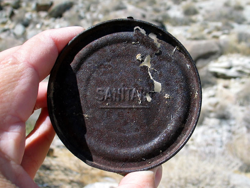 In 1904 the open-top can introduced by the Sanitary Can Company replaced the older hole and cap cans.  These cans were embossed with the word Sanitary as you can see here.