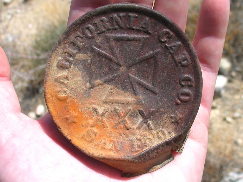 This is a good find!  It's the lid to a blasting cap tin.  We love the abbreviation for San Francisco, 