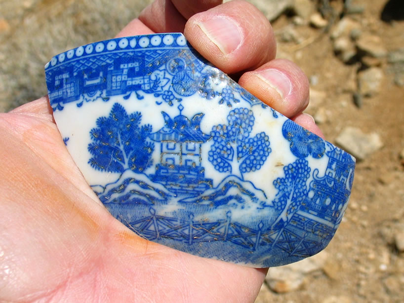 A beautiful pottery fragment that not only has the design embossed into the bowl itself but also has subtle gold paint highlights that can still be seen.