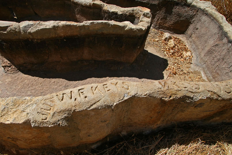 His name is imprinted in cement on the top of one of the sides.