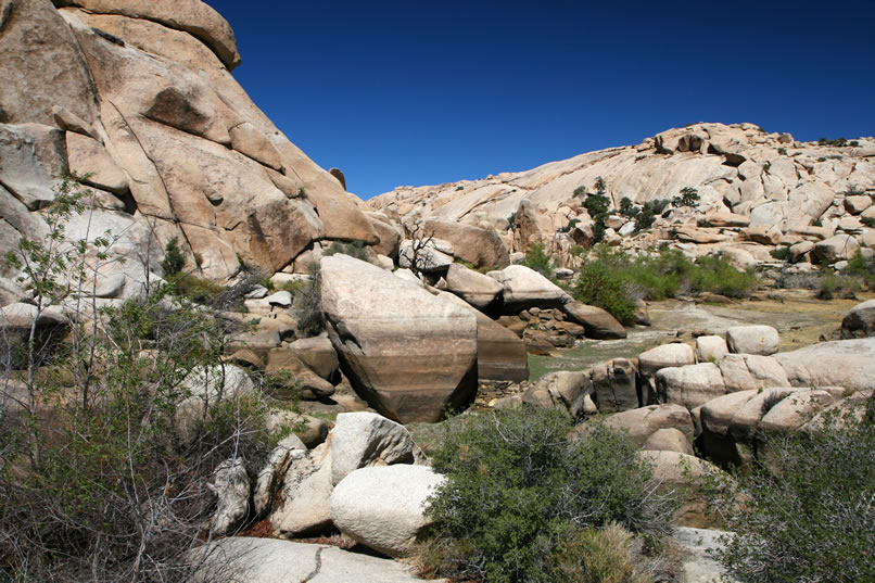 Although this year's lack of rainfall has left only a small pond behind the dam, you can nonetheless see the marks of previous high water lines coloring the now uncovered boulders. 