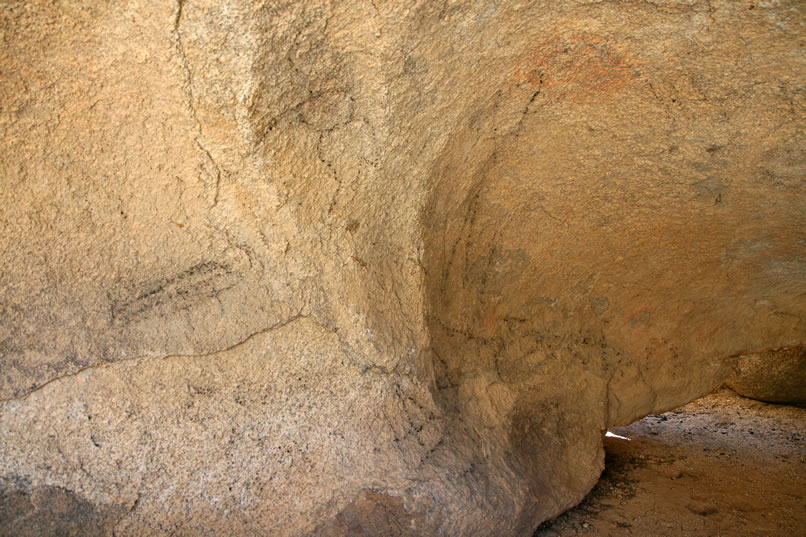 A hollowed out boulder near the top of the dam bears the charcoal attempts of tourists to recreate a semblance of prehistoric pictographs.  However, a red blob near the ceiling of the shelter is, in fact, an authentic pictograph.