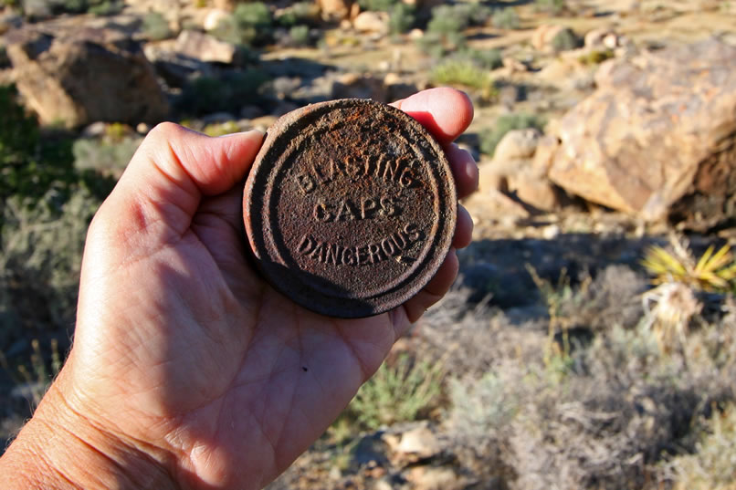 Near one of the pits is the lid to an old tin of blasting caps produced by the California Cap Company.