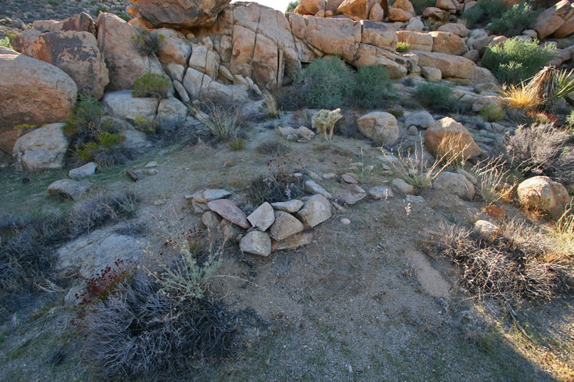 Just around the corner, on a patch of raised ground, is evidence of another bit of stacked rocks, possibly from a second tent cabin.