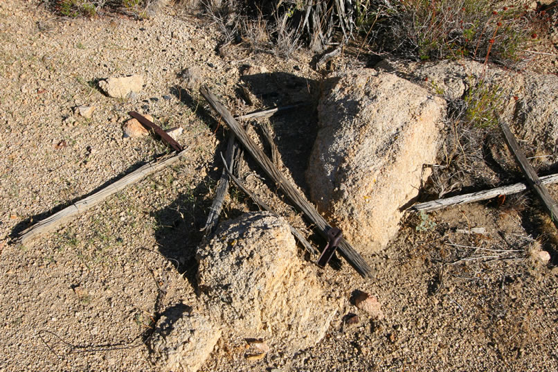 Near this second site are the remains of a wooden folding cot frame.