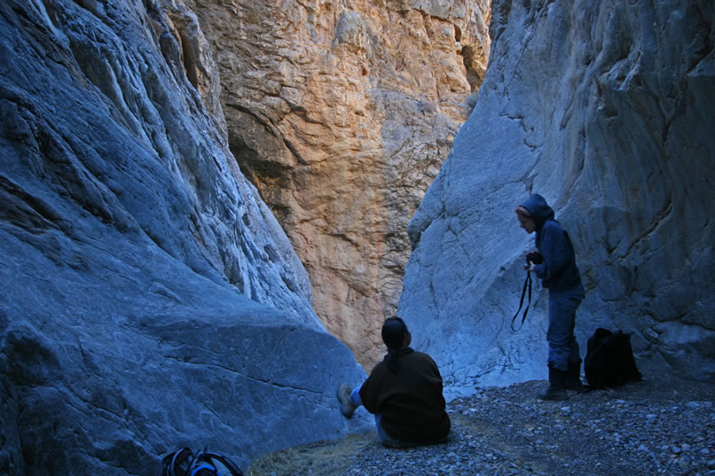 Once a climber reaches Micah's belay, there's another short steep section before reaching what can best be described as hollowed out womb of rock midway between the steep dryfall chute that we're coming up now and another one that empties into the bowl from above.  Alysia and Annie are watching the rest of the crew slowly make their way up here.