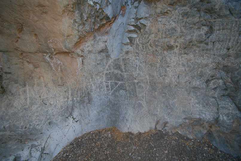 As we work our way clockwise around the bowl we can see the sheer volume of artwork that's been inscribed here over the ages.  Just above the large circle petroglyph is the lower end of the equally long and steep chute which drops into the bowl.