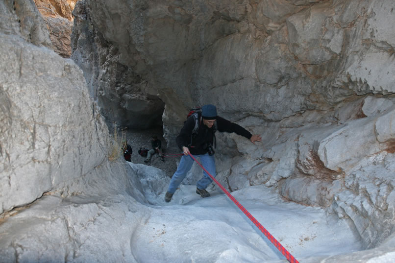 Guy, hardly using the rope at all, deftly scampers up as well.