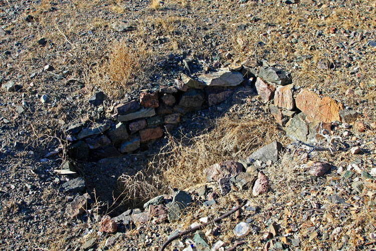 The reason we were interested in the hill to the east of the spring is because on top of it there is evidence of some structures and a scatter of some historic debris.  This little rock lined dug-out is interesting.