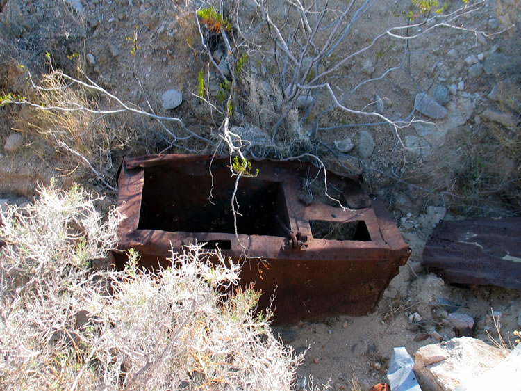 We find a large cook stove in the wash behind the cabin.