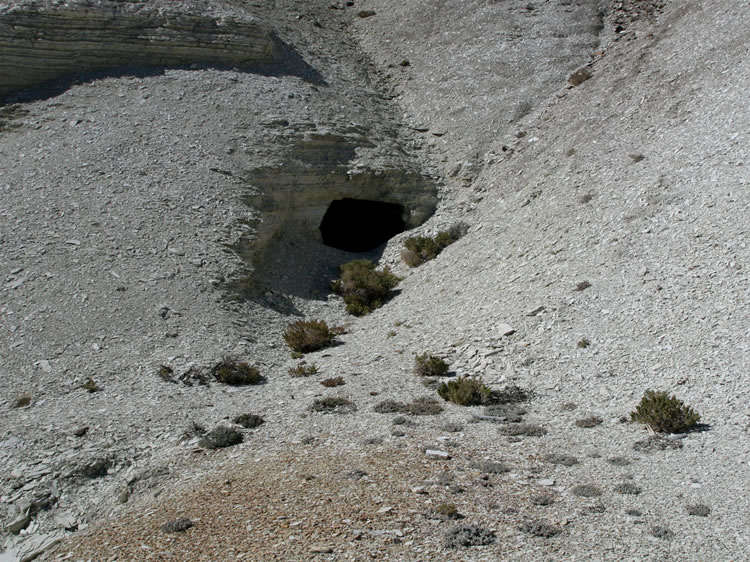 Up a steep hillside near the ruin we find a small adit.