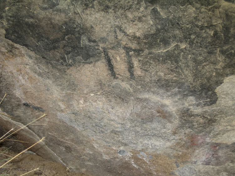 Here's another part of the shelter wall.  You can see that there appears to be a human-like stick figure in the center as well as a short horizontal line in the lower left.  Rolling your mouse over the picture once again brings back to life some faded red pictograph elements in the lower right.