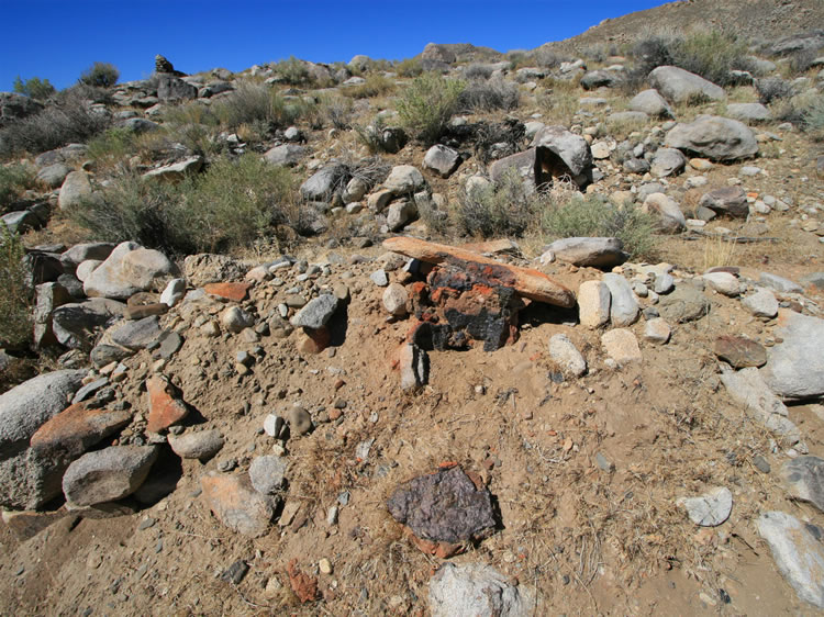 Not too far from one of the larger cabin ruins we find what appears to be the remains of a small smelter oven.