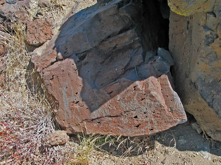 The figure at the left appears to have a bow in hand and to be engaged in hunting the bighorn sheep.