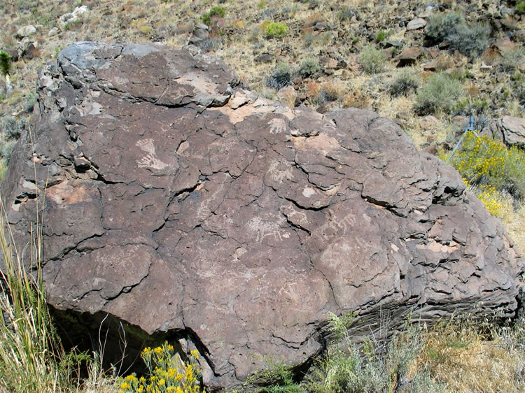 Can you find the hand print and the two foot prints on this boulder?