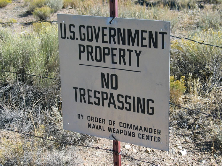 A short distance from the end of the canyon is the fence marking the boundary of the China Lake Naval Weapons Center.  It's getting late anyway and a cool wind is blowing as we start our trek back to the truck.