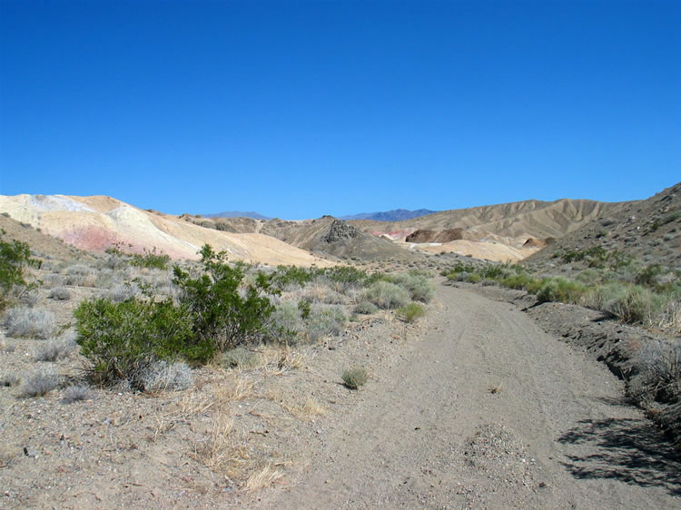 This area proves to be a little wonderland of colorful hills covered with sparkling selenite crystals and carpeted with salts of magnesium carbonate and sulfate.