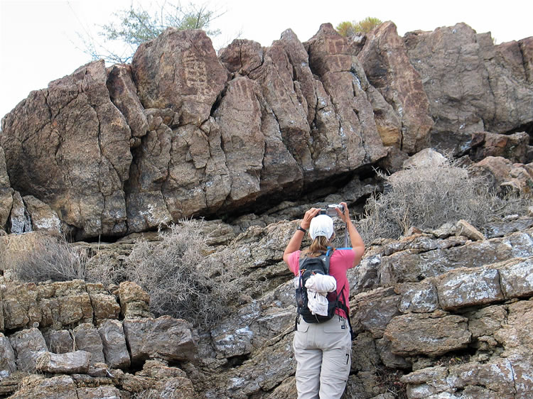 The rock surface is quite weathered but the glyphs can still be easily seen.