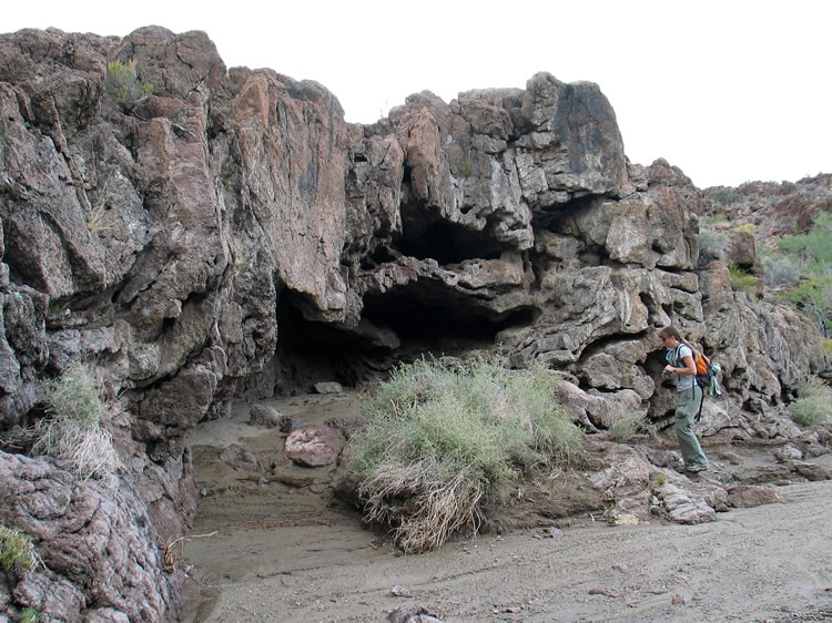 A little further along we come to another dike which crosses the wash.  This one has been sculpted into several small caves.