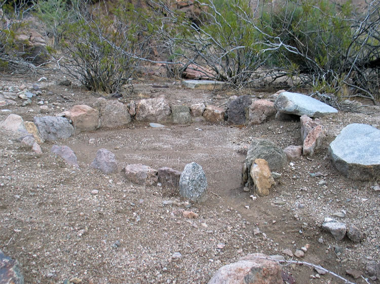 A different view of the arrastra and the flattened stones to the right.