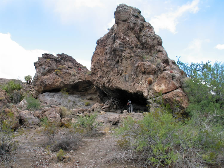 A look back from the spring at Jamie in the rock shelter.