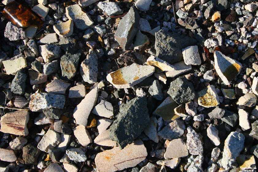 The ground is littered with the remains of broken crucibles and the smaller cupels.