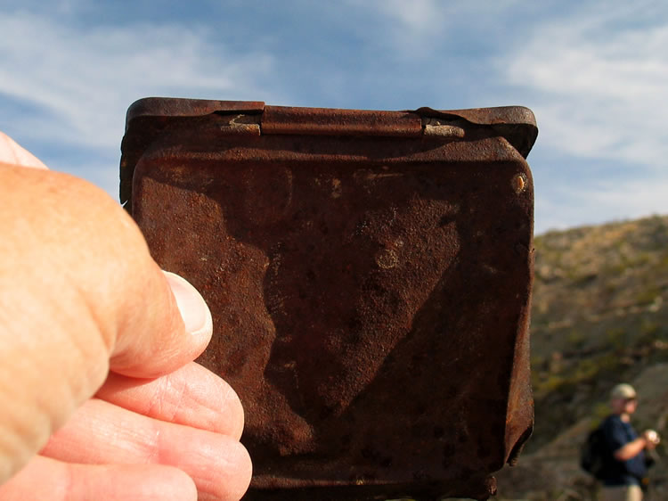 This flat tin container might have once contained cigarette papers.