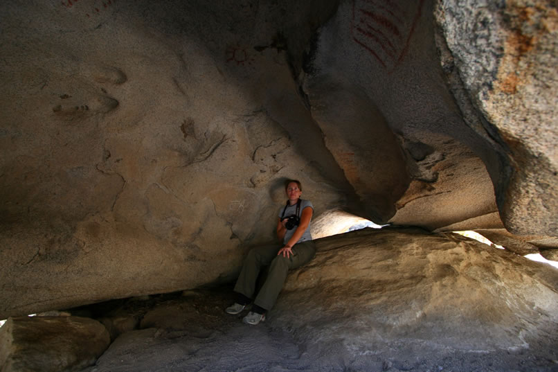Here's a look at Niki sitting at the back of the shelter, its south end.  If you look closely, you can see four pictograph elements and one possible petroglyph.