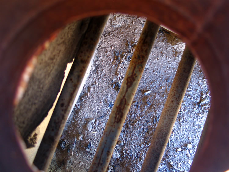 Here's a look down through the vent at the pipes that carried the water which was then warmed by the fire below.