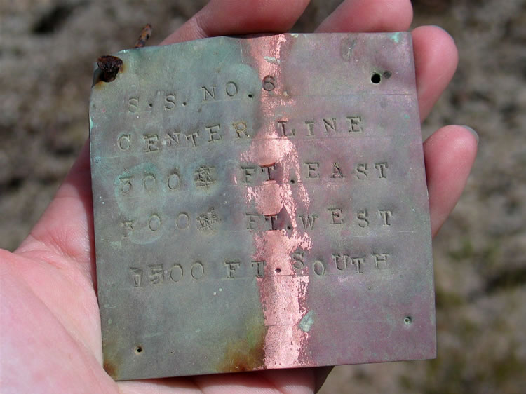 Inside, folded in half, is a copper plate incised with the claim info.  This is a nice find and a first for us.  We carefully return the copper plate to its resting place.