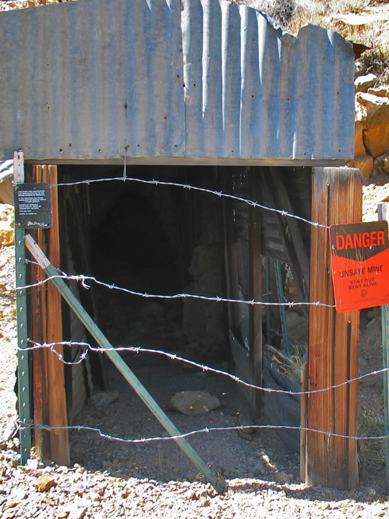 The sign is telling the truth.  The previous shaft and this tunnel are in really bad condition.  At one time there were over 4,000 feet of tunneling, but in its later years the mine switched to open cut methods in order to reduce costs.