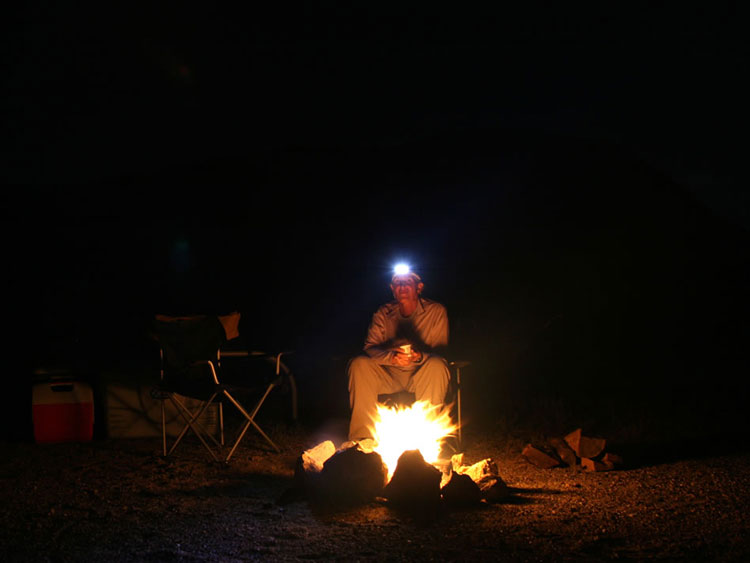 Jamie, assisted by her trusty headlamp, having her yogurt dessert.