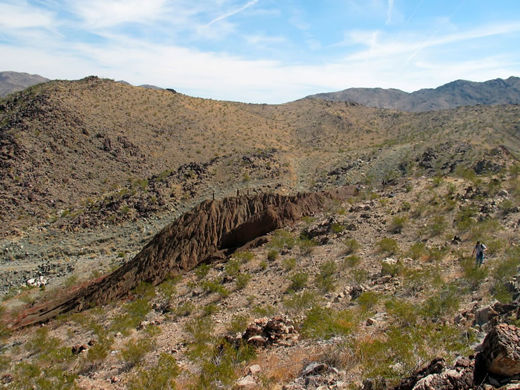 Below the can dump is an old eroded trail that leads to the lower workings.