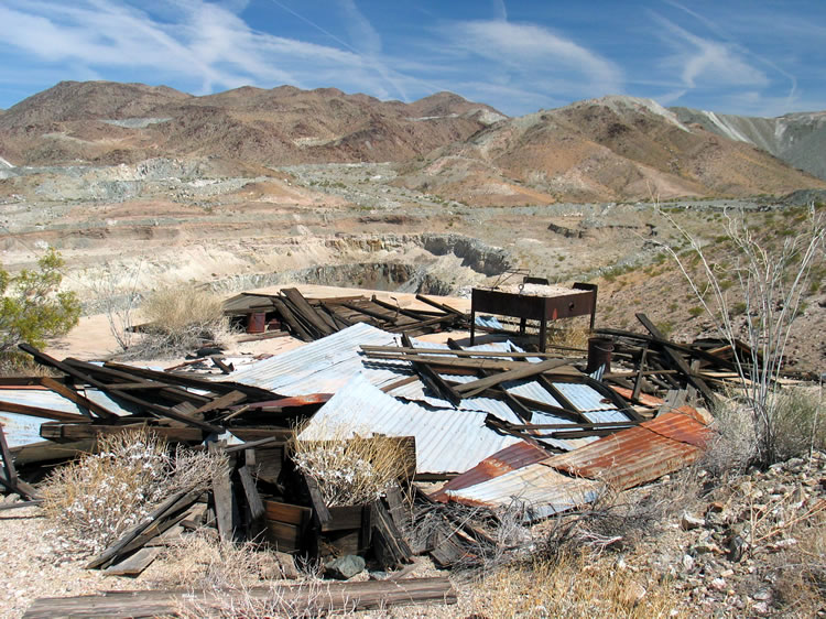 The pan forge standing amidst the rubble marks this as the blacksmith shop.