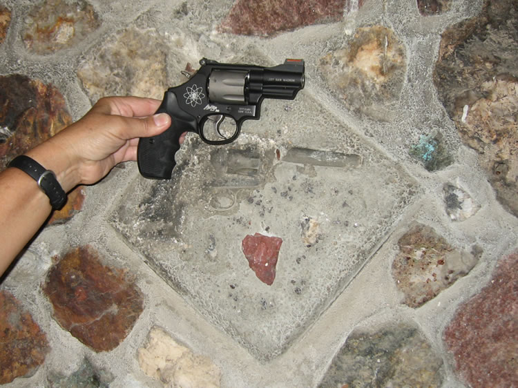 Inside, above the fireplace mantle, it appears that a revolver had been inset into the mortar.